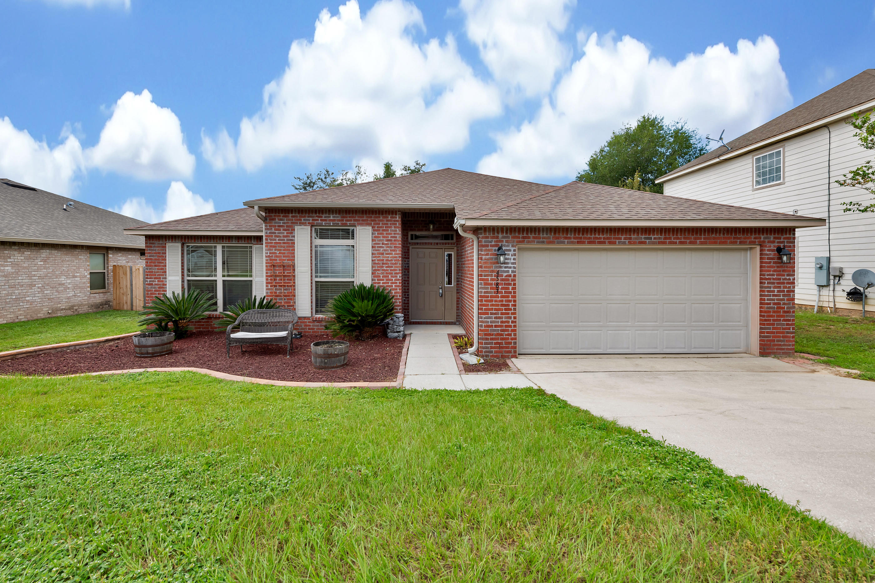 4583 Hermosa Road Crestview, FL 32539 - Photo 1 of 24 a view of a house with a yard and sitting area