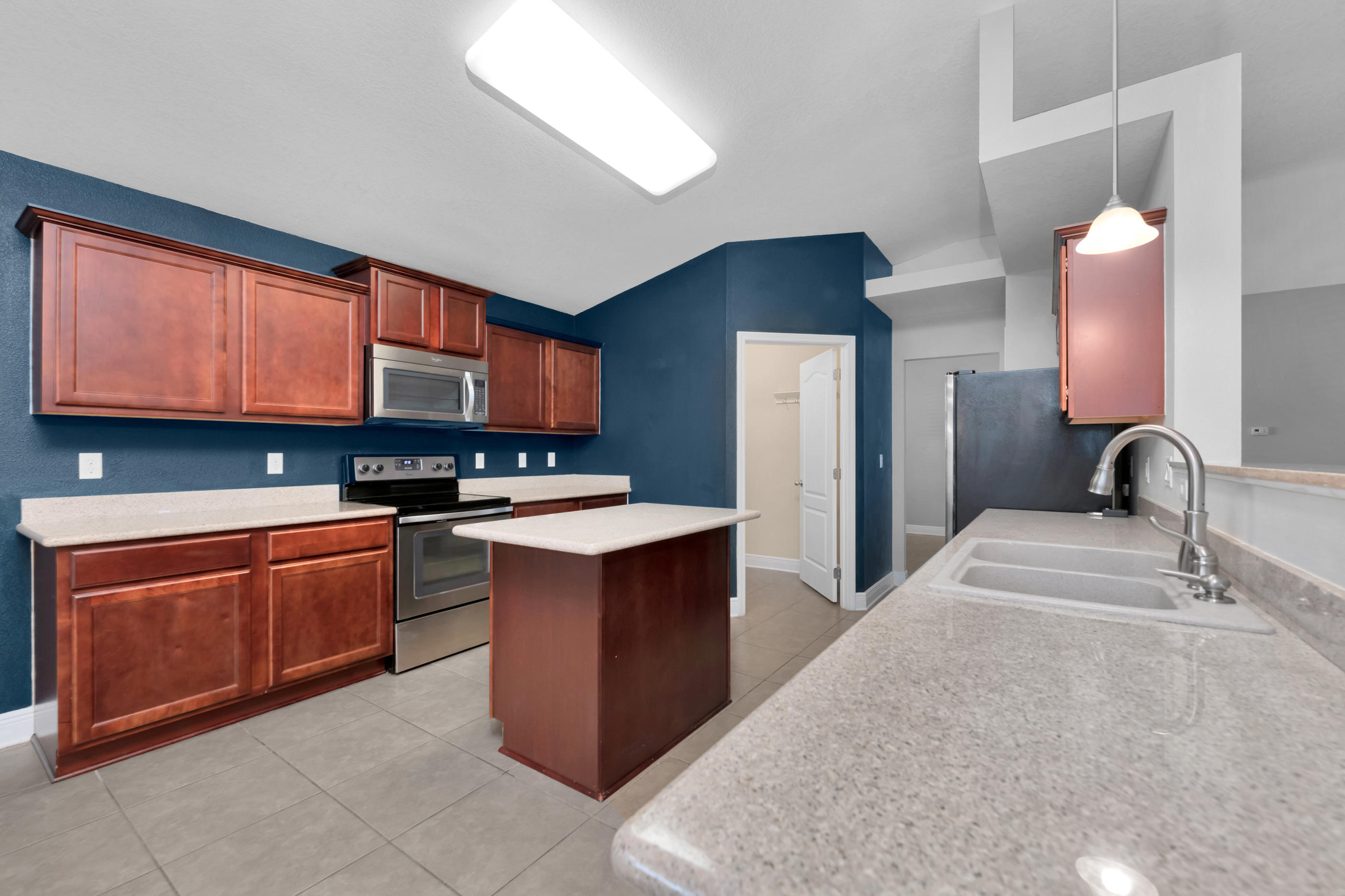 4583 Hermosa Road Crestview, FL 32539 - Photo 12 of 24 a kitchen with stainless steel appliances granite countertop wooden cabinets a stove top oven a sink and dishwasher