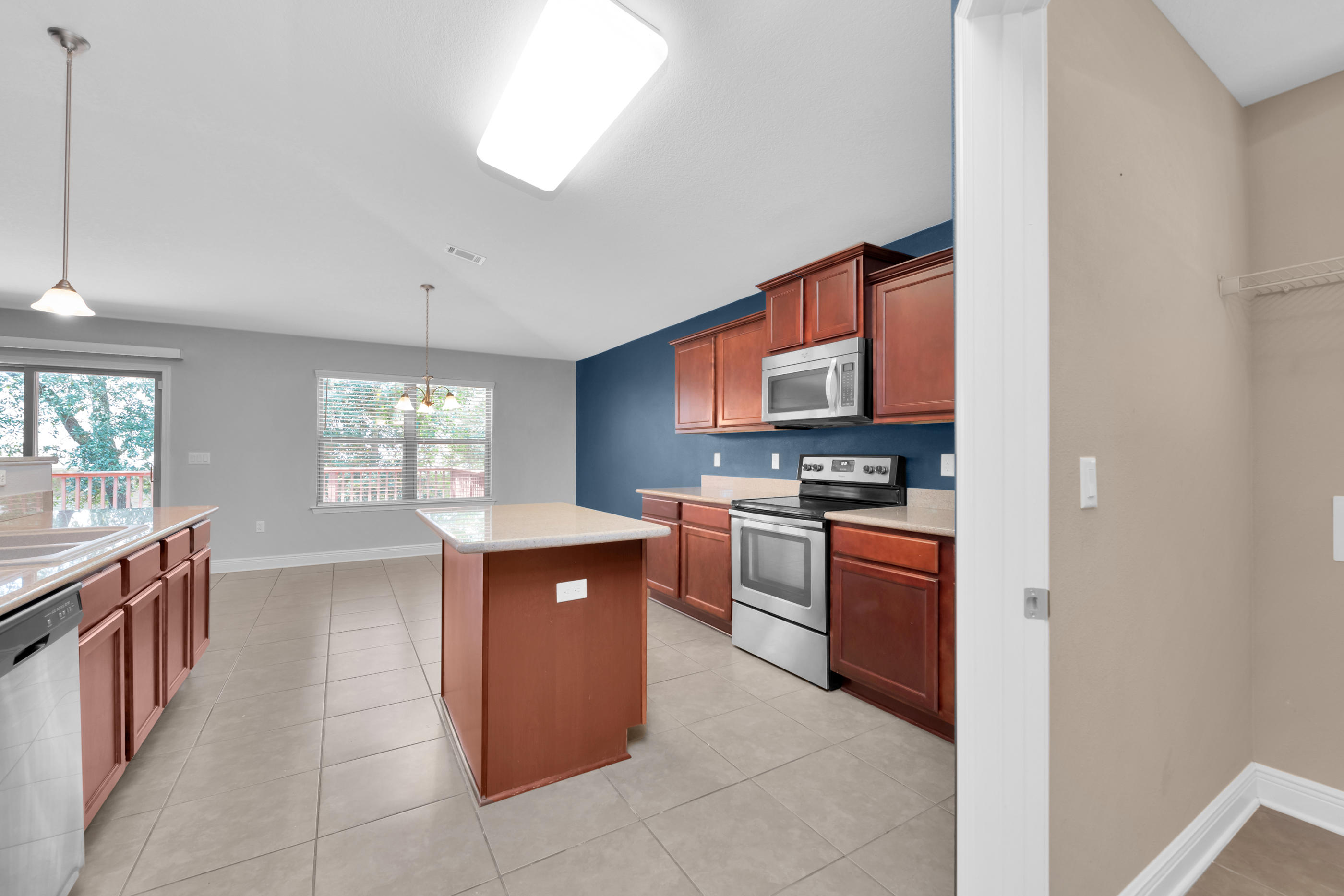 4583 Hermosa Road Crestview, FL 32539 - Photo 14 of 24 a kitchen with stainless steel appliances granite countertop a stove top oven a sink a counter top space and cabinets