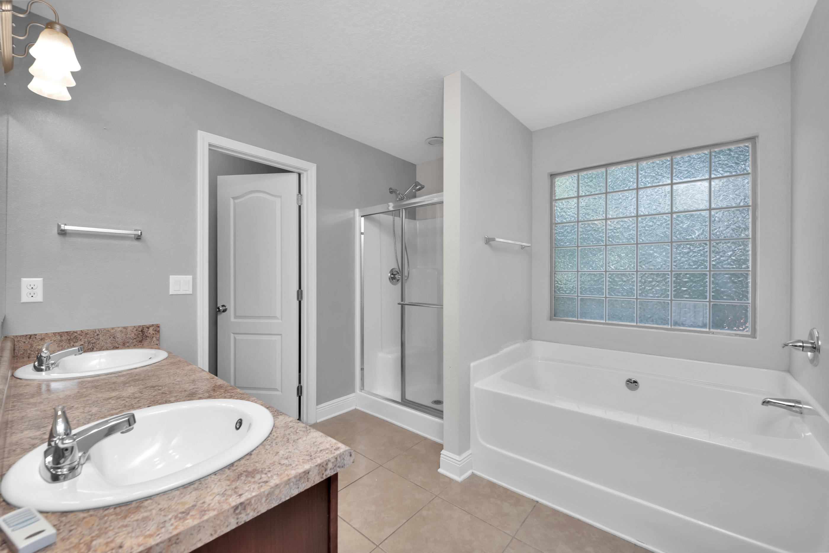 4583 Hermosa Road Crestview, FL 32539 - Photo 18 of 24 a bathroom with a granite countertop tub sink and mirror