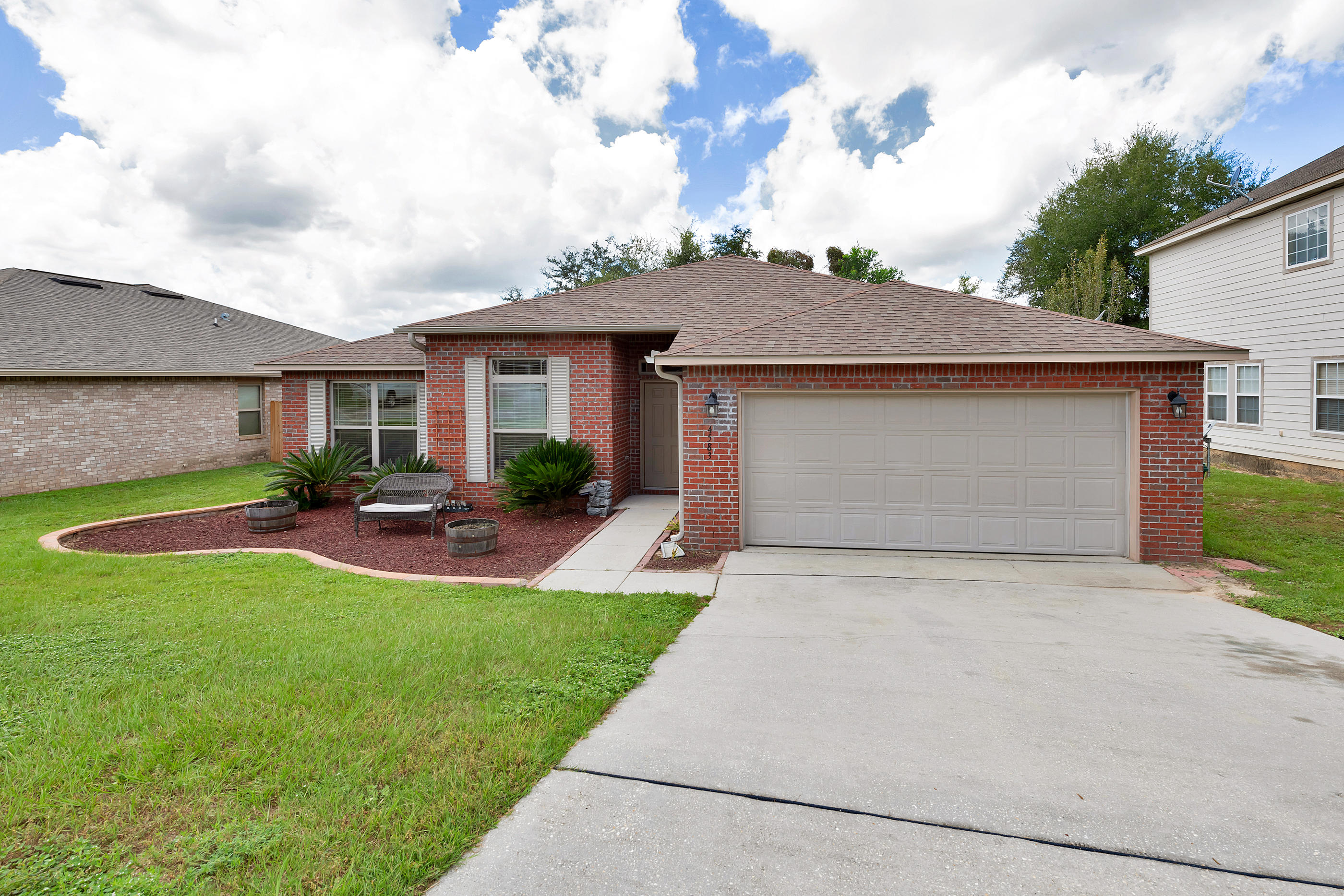 4583 Hermosa Road Crestview, FL 32539 - Photo 3 of 24 a front view of a house with patio and garden