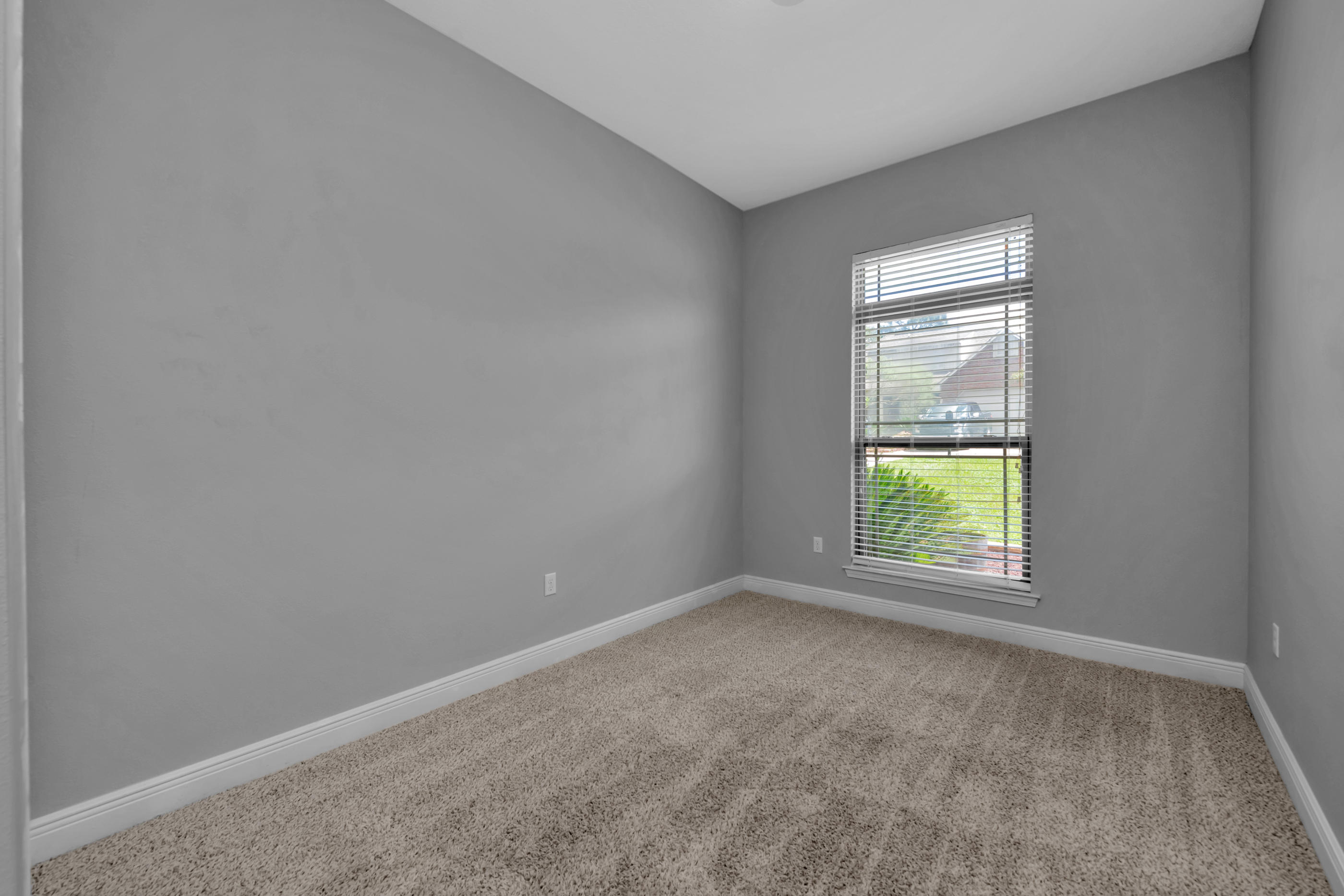 4583 Hermosa Road Crestview, FL 32539 - Photo 21 of 24 an empty room with a window and wooden floor