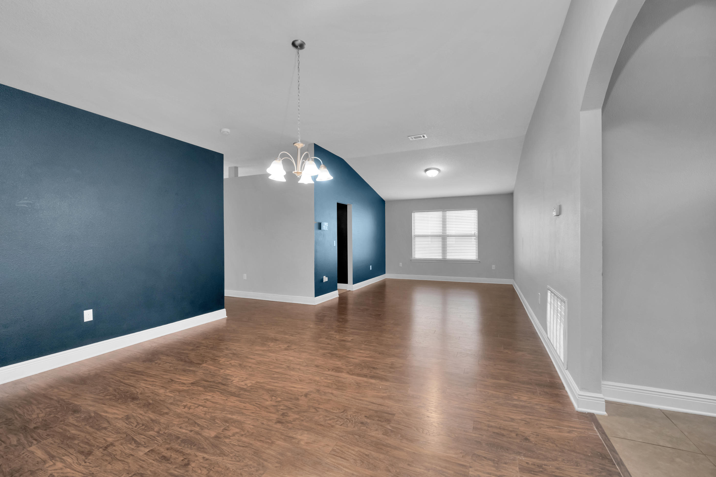 4583 Hermosa Road Crestview, FL 32539 - Photo 5 of 24 a view of empty room with window and wooden floor