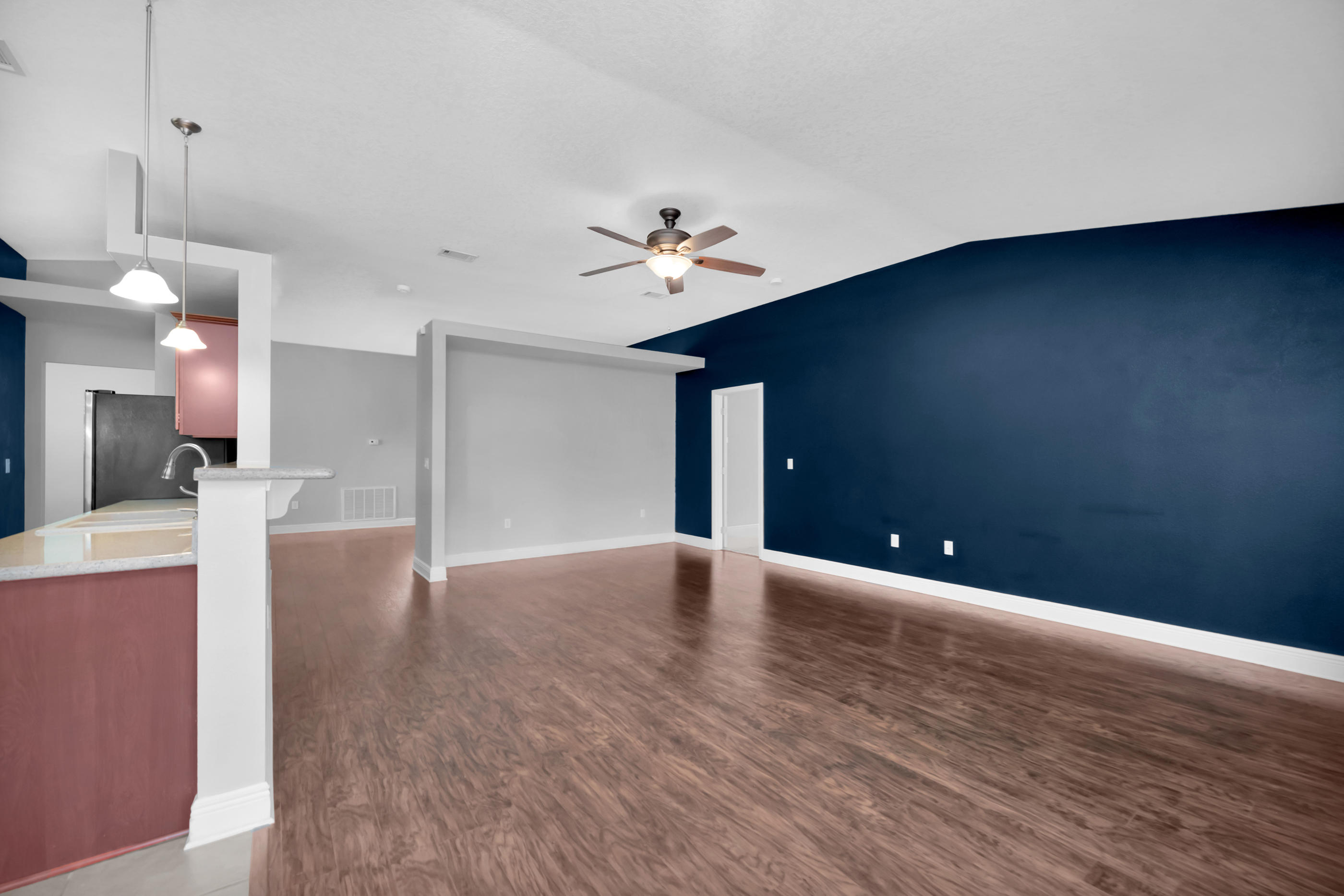 4583 Hermosa Road Crestview, FL 32539 - Photo 8 of 24 a view of an empty room with a window and a kitchen