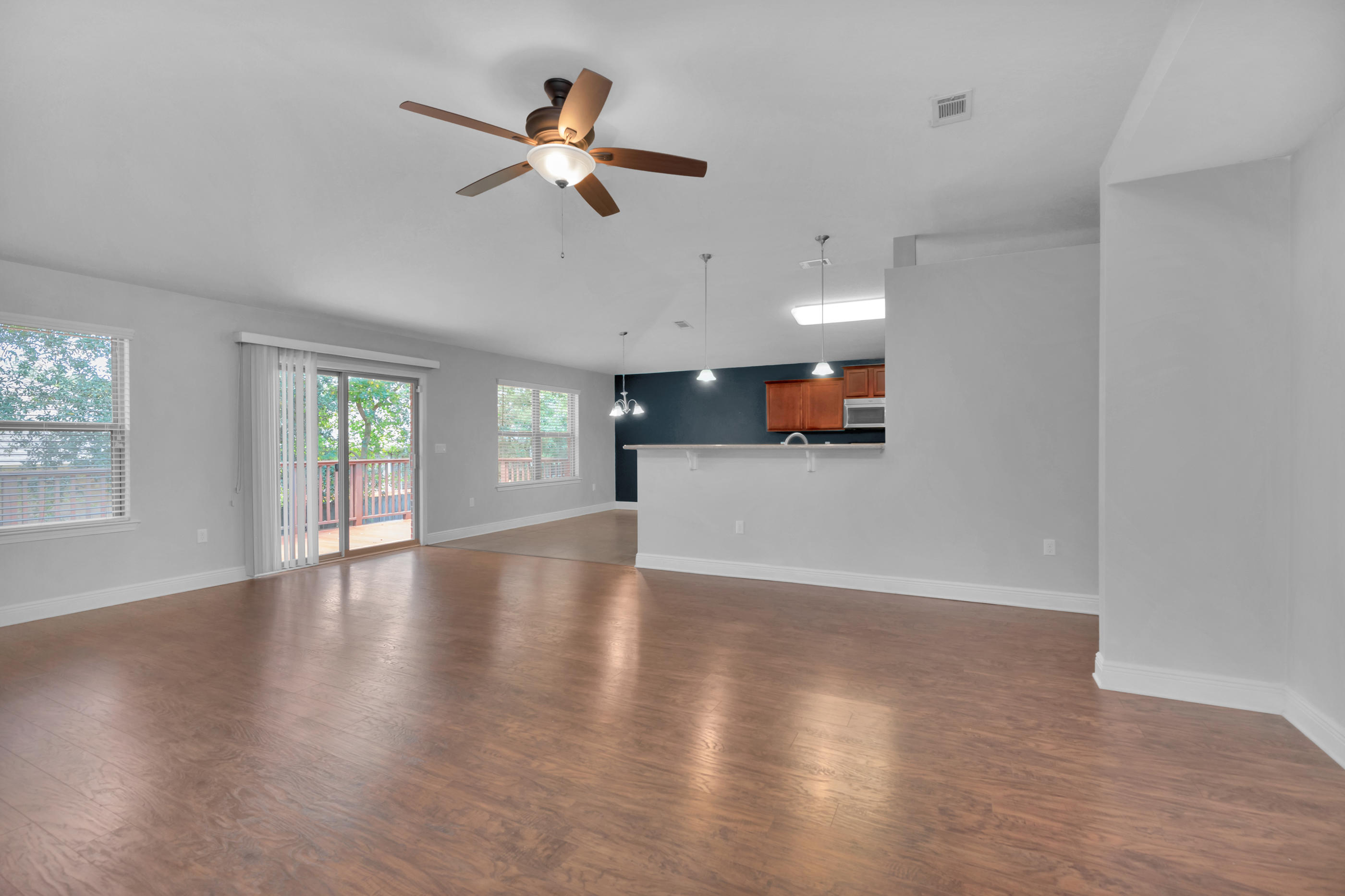 4583 Hermosa Road Crestview, FL 32539 - Photo 9 of 24 a view of a livingroom with a ceiling fan and wooden floor