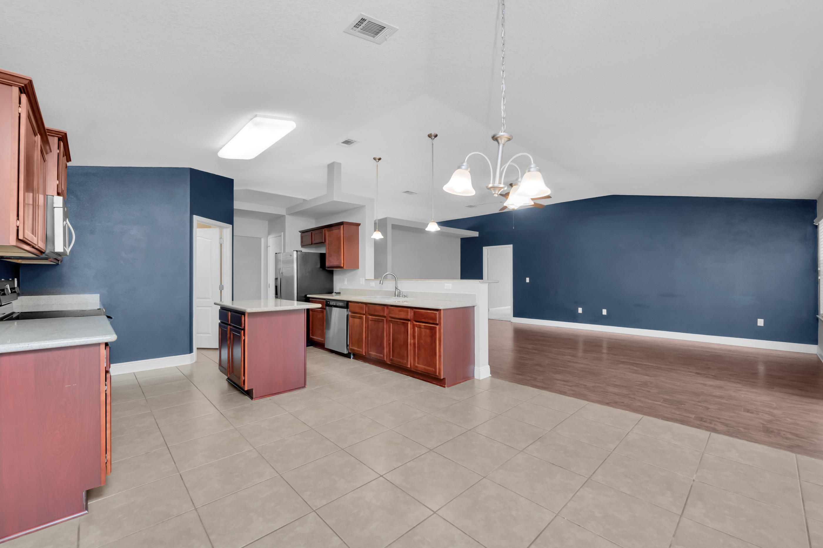 4583 Hermosa Road Crestview, FL 32539 - Photo 10 of 24 a large kitchen with stainless steel appliances a large counter top a stove and a sink