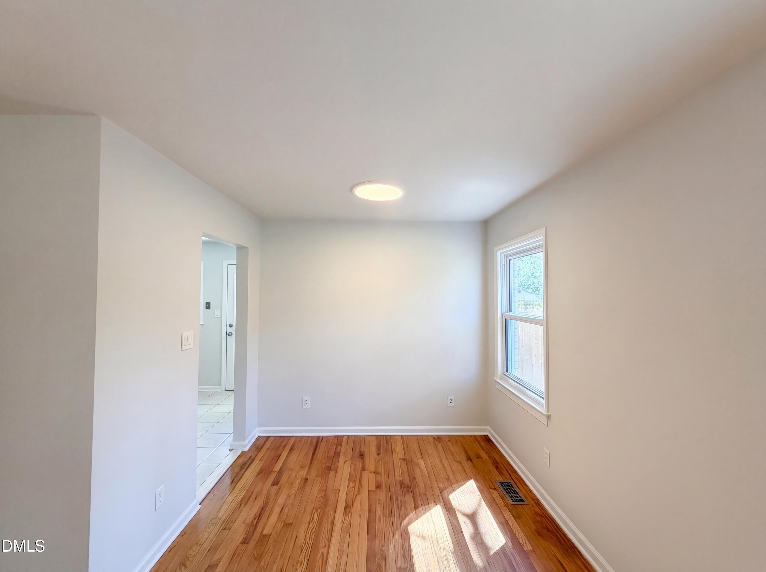 910 Devonport Drive Raleigh, NC 27610 - Photo 6 of 16 a view of empty room with wooden floor and fan