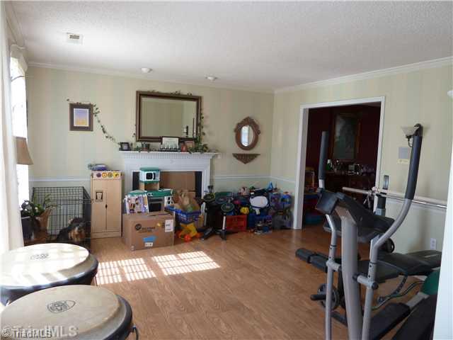 3601 Single Leaf Court High Point, NC 27265 - Photo 11 of 16 Living Room. Living/Den looking toward gas fireplace. Please notice ceiling-mounted accent lighting above fireplace!