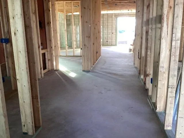 a view of an empty room with floor to ceiling window and staircase