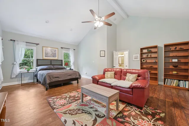a bedroom with furniture and a large window