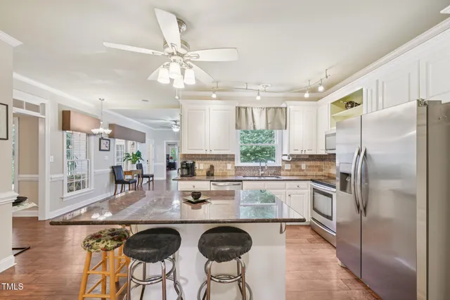 a kitchen with refrigerator cabinets and dining table