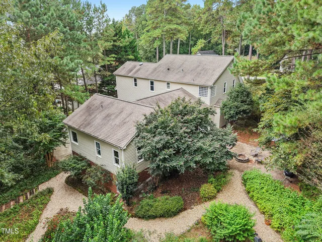 an aerial view of a house with yard and green space