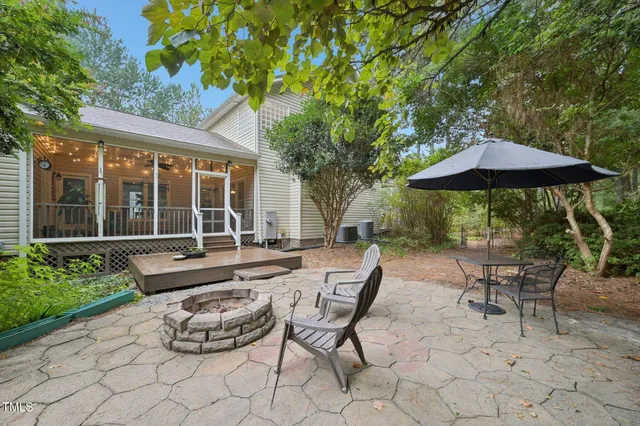 a view of a patio with table and chairs under an umbrella