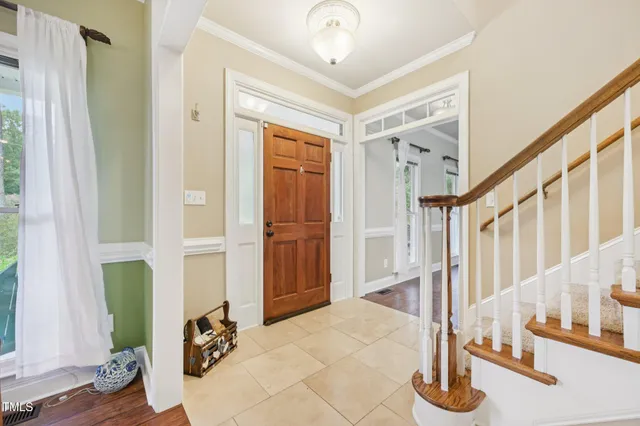 a view of entryway and hall with wooden floor
