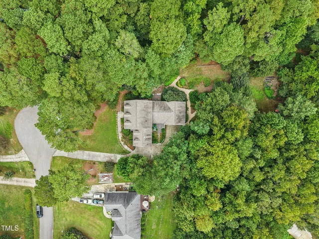an aerial view of a house with yard swimming pool and outdoor seating