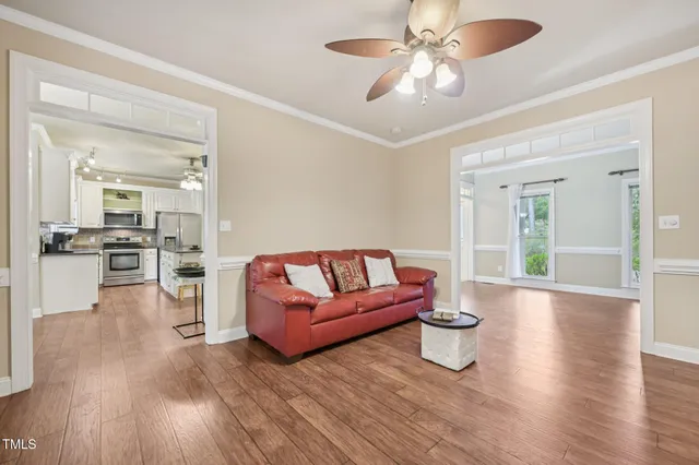 a living room with furniture and wooden floor