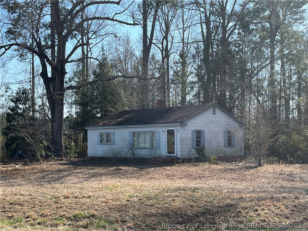 a view of a yard with a house and a tree