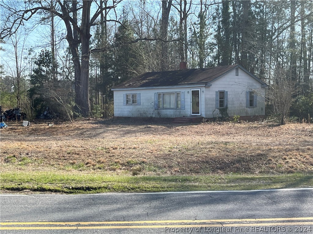1712 Hayes Road Spring Lake, NC 28390 - Photo 2 of 13 a front view of a house with a yard covered with trees
