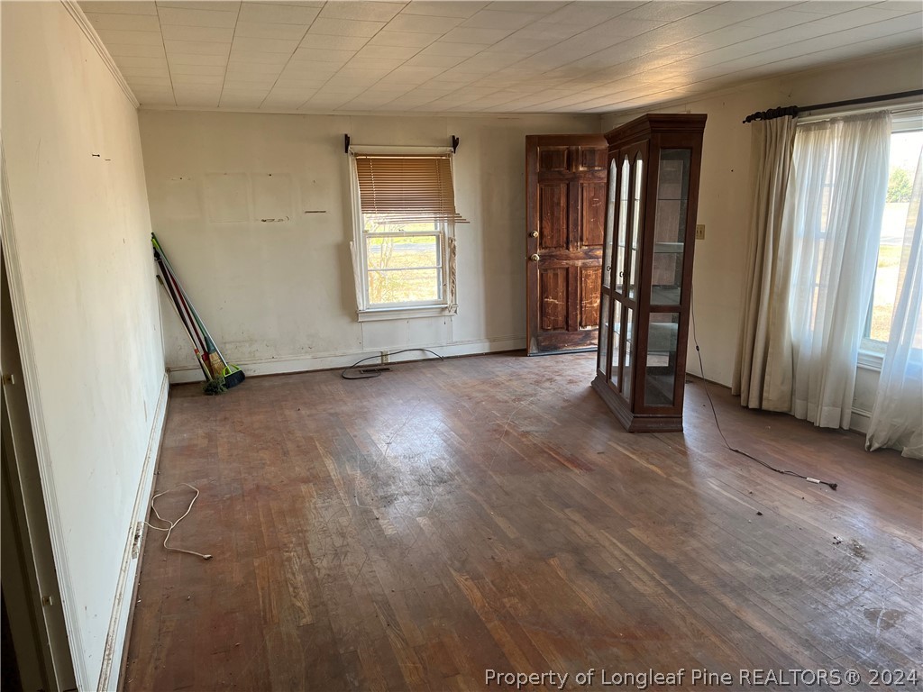 1712 Hayes Road Spring Lake, NC 28390 - Photo 4 of 13 an empty room with wooden floor and windows