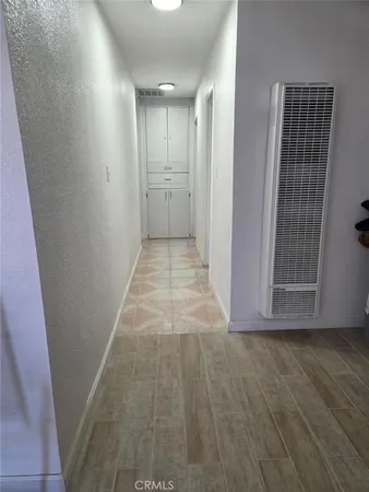 a view of hallway with wooden floor