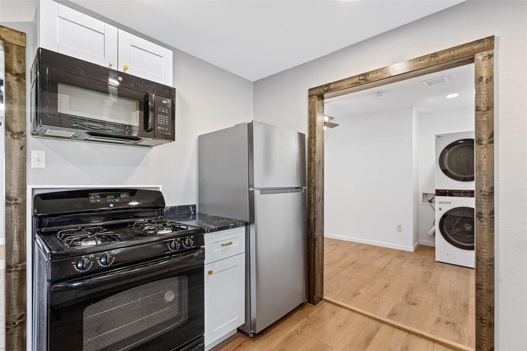 902 Turner Street Cleburne, TX 76033 - Photo 15 of 33 a kitchen with a refrigerator and a stove top oven