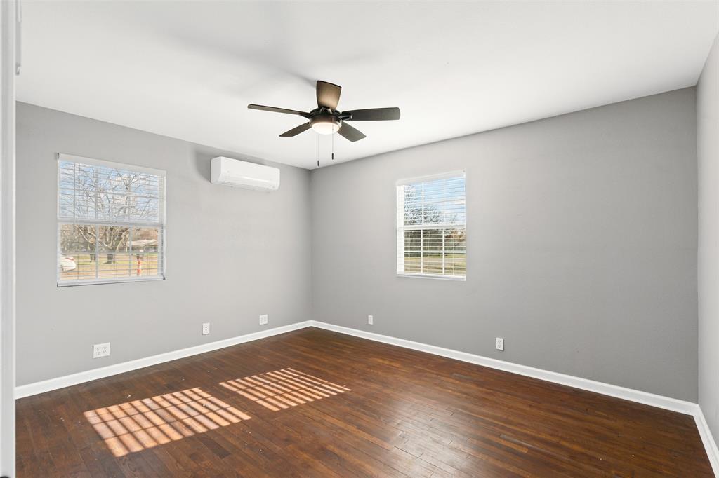 902 Turner Street Cleburne, TX 76033 - Photo 20 of 33 a view of an empty room with a window and wooden floor
