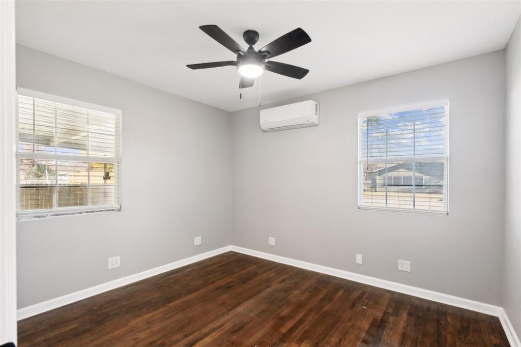 902 Turner Street Cleburne, TX 76033 - Photo 25 of 33 a view of an empty room with wooden floor and a window