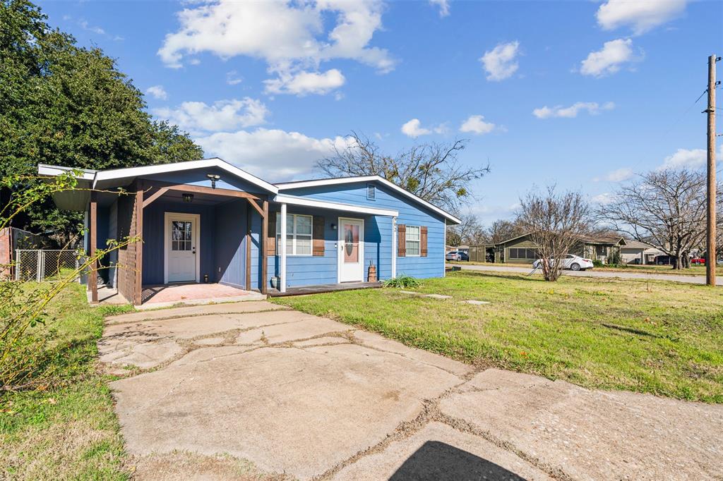 902 Turner Street Cleburne, TX 76033 - Photo 32 of 33 a front view of a house with a garden and trees