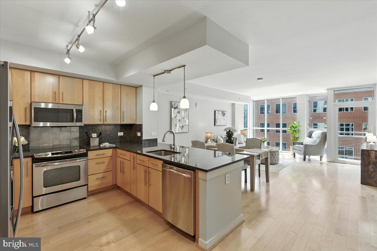 a kitchen with lots of counter top space and stainless steel appliances