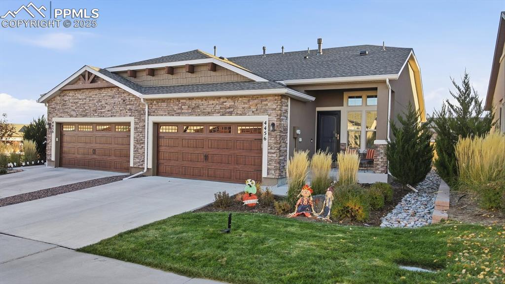 4456 Hessite Loop Colorado Springs, CO 80938 - Photo 1 of 42 a front view of a house with a yard