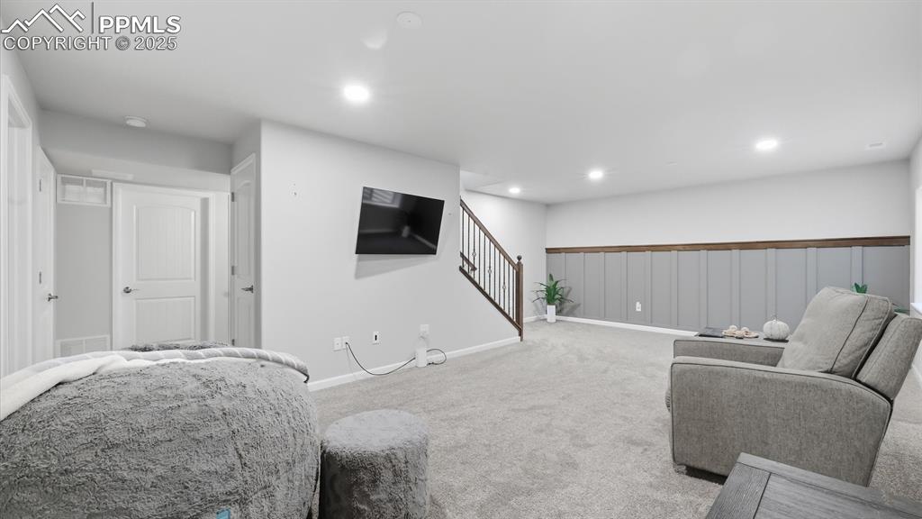 4456 Hessite Loop Colorado Springs, CO 80938 - Photo 26 of 42 a living room with furniture and a flat screen tv