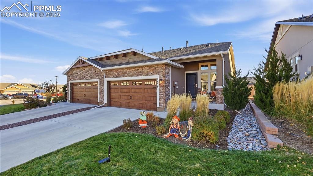 4456 Hessite Loop Colorado Springs, CO 80938 - Photo 4 of 42 a front view of a house with garden