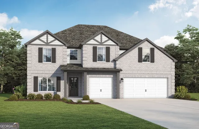 a front view of a house with a yard and garage