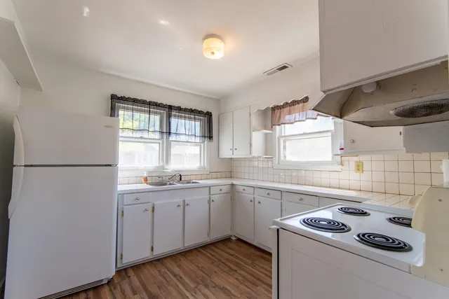 a kitchen with a sink a stove and cabinets