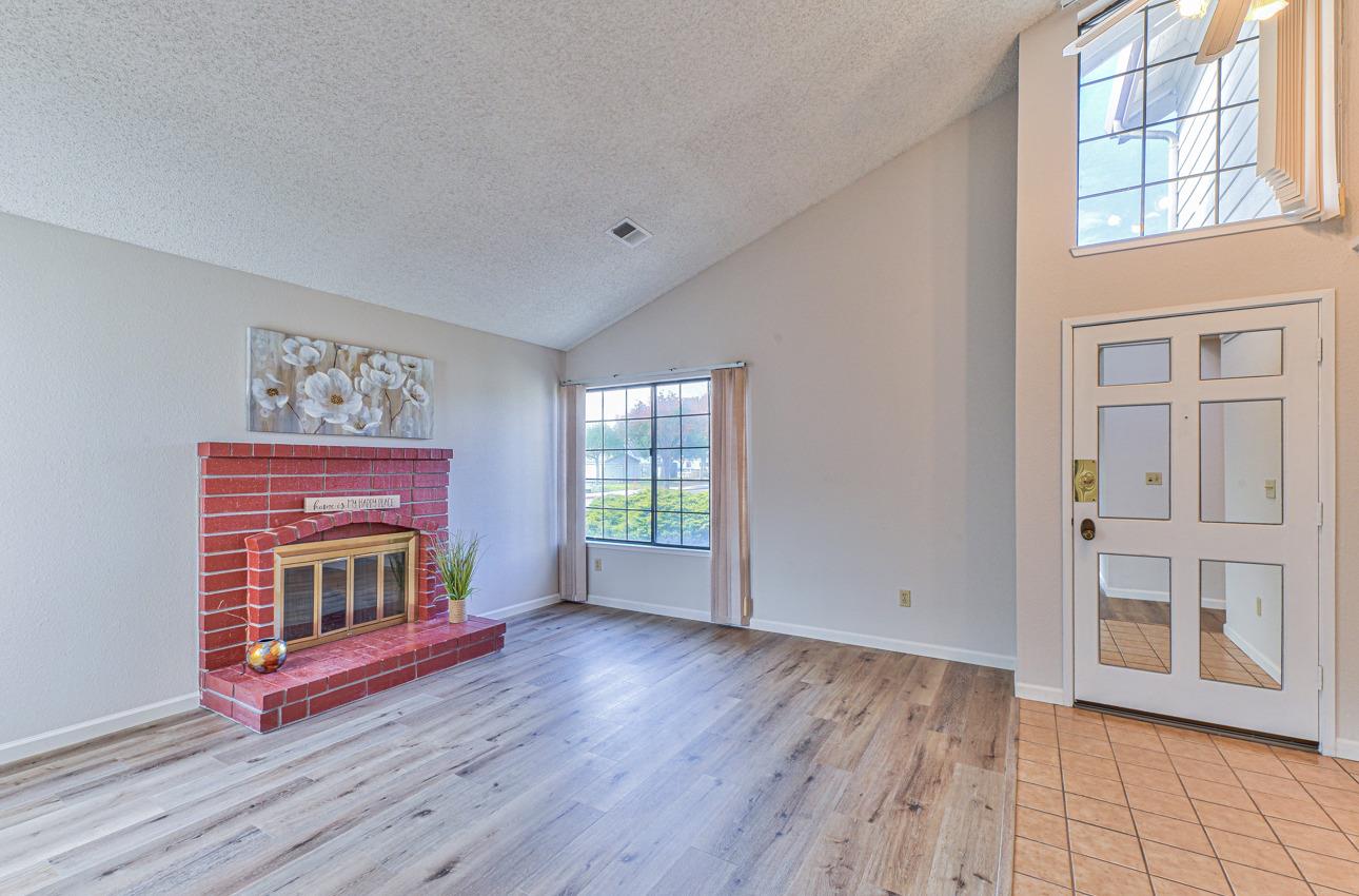 2 Geary Circle Salinas, CA 93907 - Photo 3 of 29 an empty room with wooden floor fireplace and windows