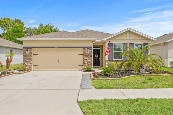 a front view of a house with a yard and garage