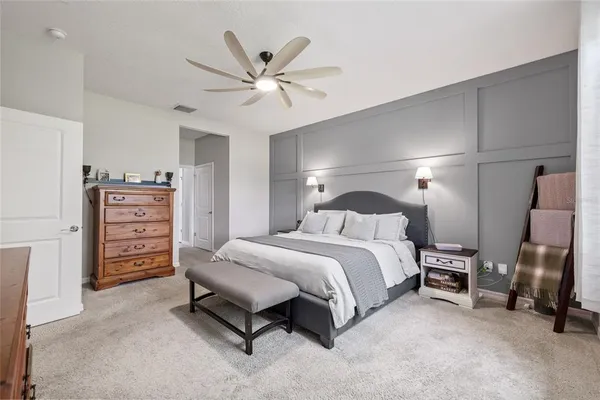 a spacious bedroom with a bed and a cabinets
