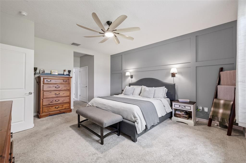 13675 Paddington Way Spring Hill, FL 34609 - Photo 14 of 36 a spacious bedroom with a bed and a cabinets