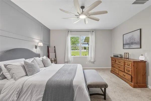a bedroom with a bed dresser and a window