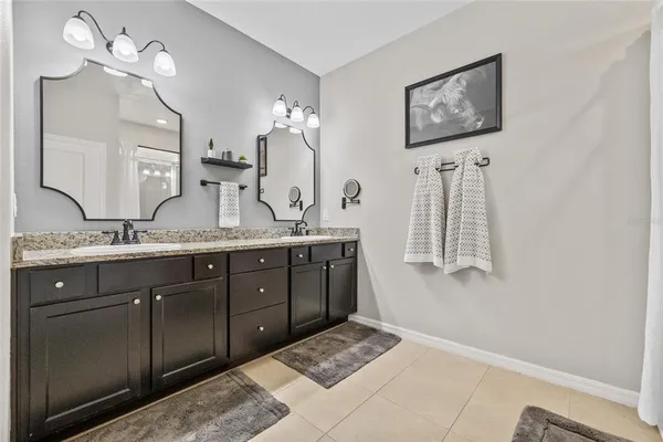 a bathroom with a double vanity sink and a mirror