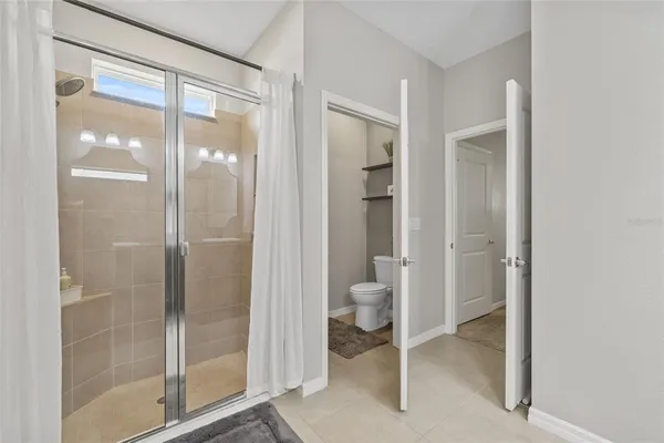 a bathroom with a glass shower door