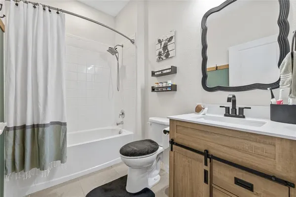 a bathroom with a granite countertop sink toilet a mirror and shower