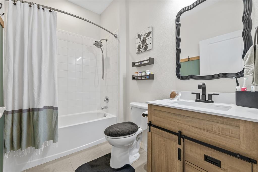 13675 Paddington Way Spring Hill, FL 34609 - Photo 22 of 36 a bathroom with a granite countertop sink toilet a mirror and shower