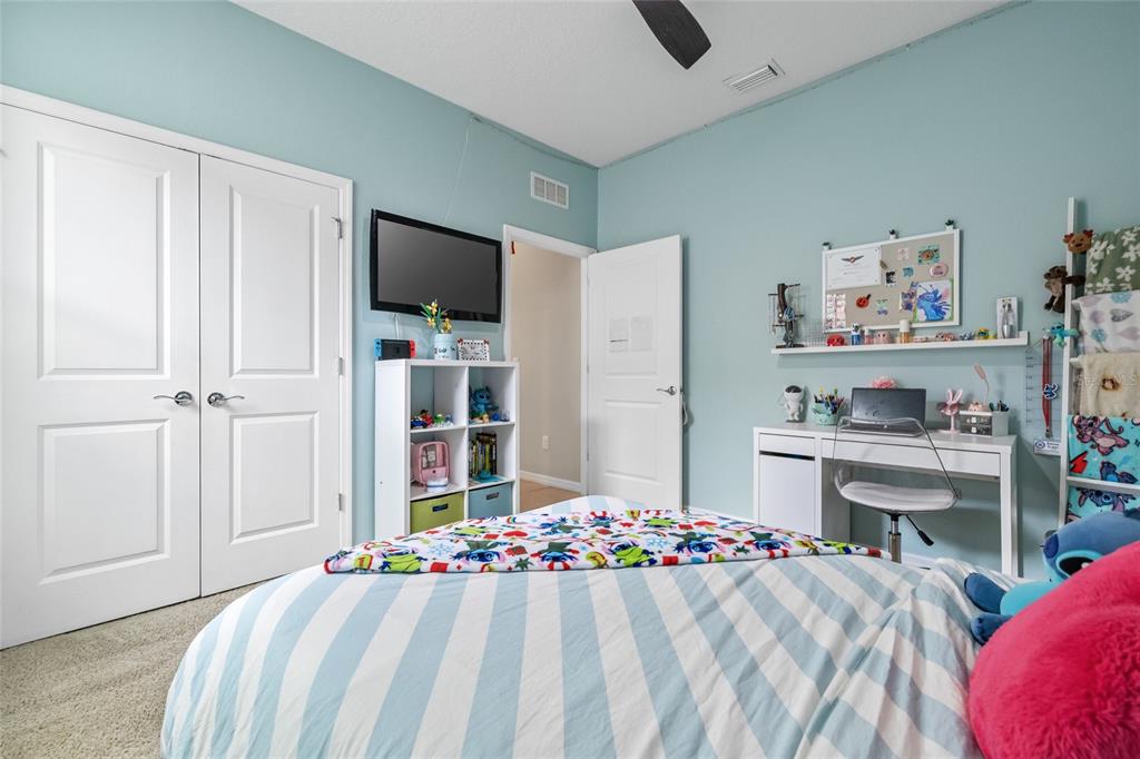 13675 Paddington Way Spring Hill, FL 34609 - Photo 24 of 36 a bed room with a bed and a chair