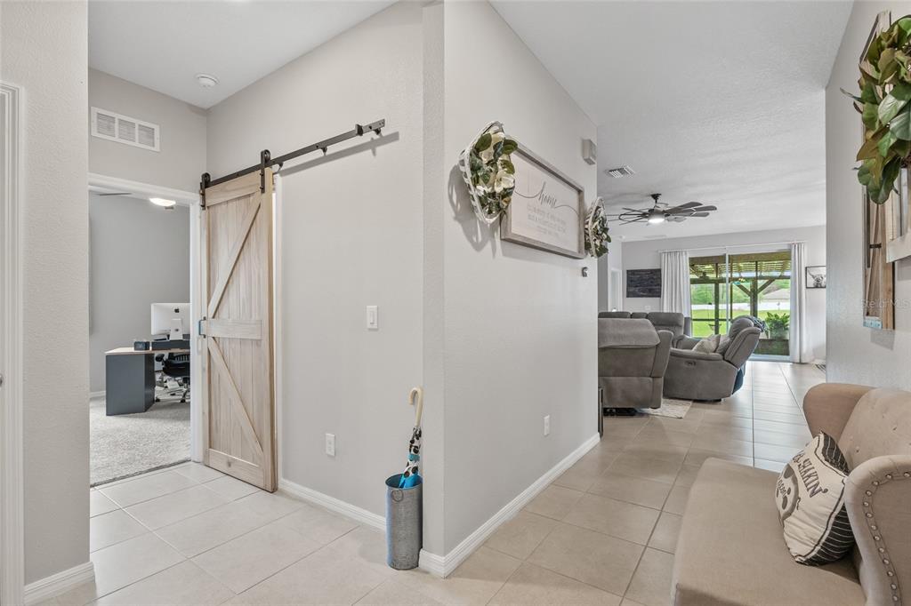 13675 Paddington Way Spring Hill, FL 34609 - Photo 25 of 36 a living room with furniture and a floor to ceiling window