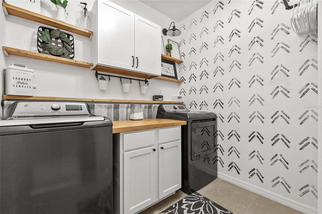 13675 Paddington Way Spring Hill, FL 34609 - Photo 28 of 36 a utility room with stainless steel appliances washer and dryer