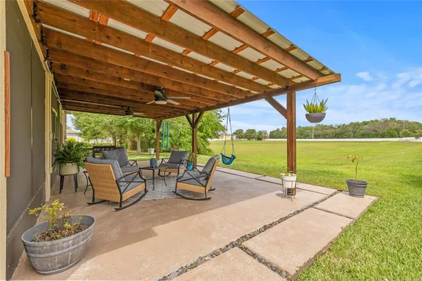 a view of a patio with a table chairs and a swimming pool