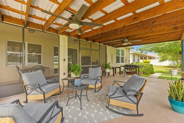a building outdoor space with patio furniture and potted plants