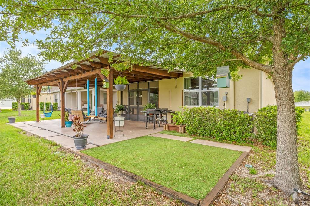 13675 Paddington Way Spring Hill, FL 34609 - Photo 31 of 36 a view of a house with backyard and sitting area