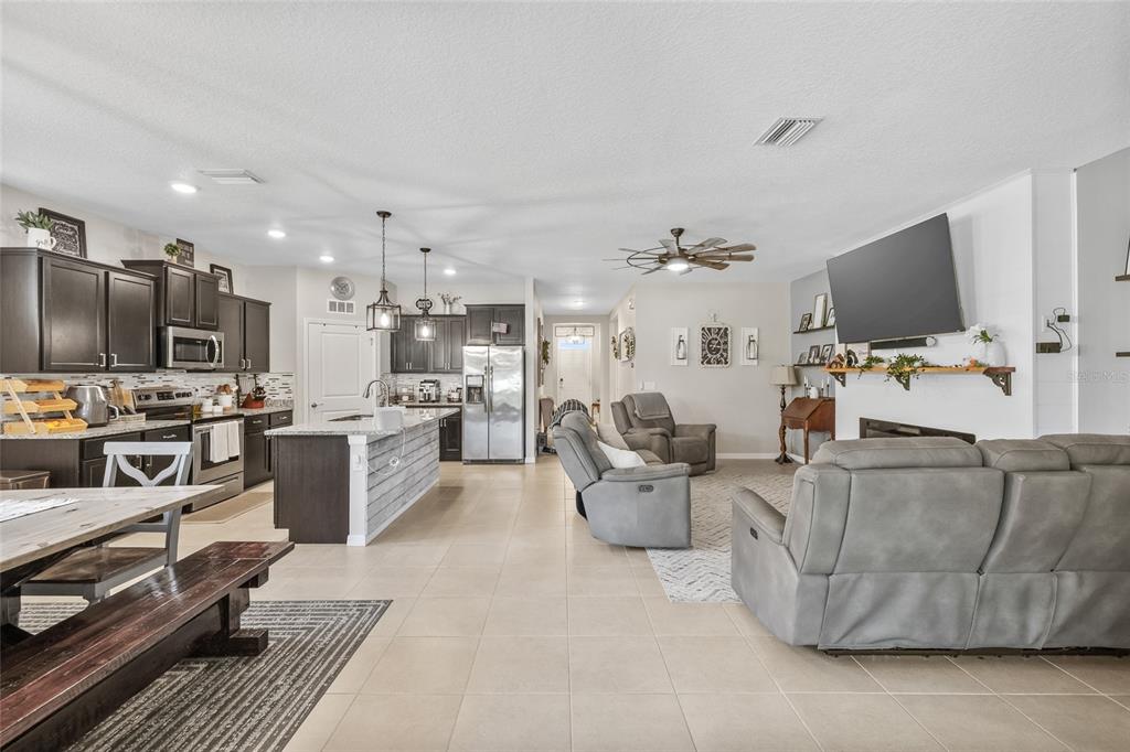 13675 Paddington Way Spring Hill, FL 34609 - Photo 5 of 36 a living room with furniture and a flat screen tv